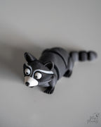Articulated raccoon figure with segmented body and striped tail