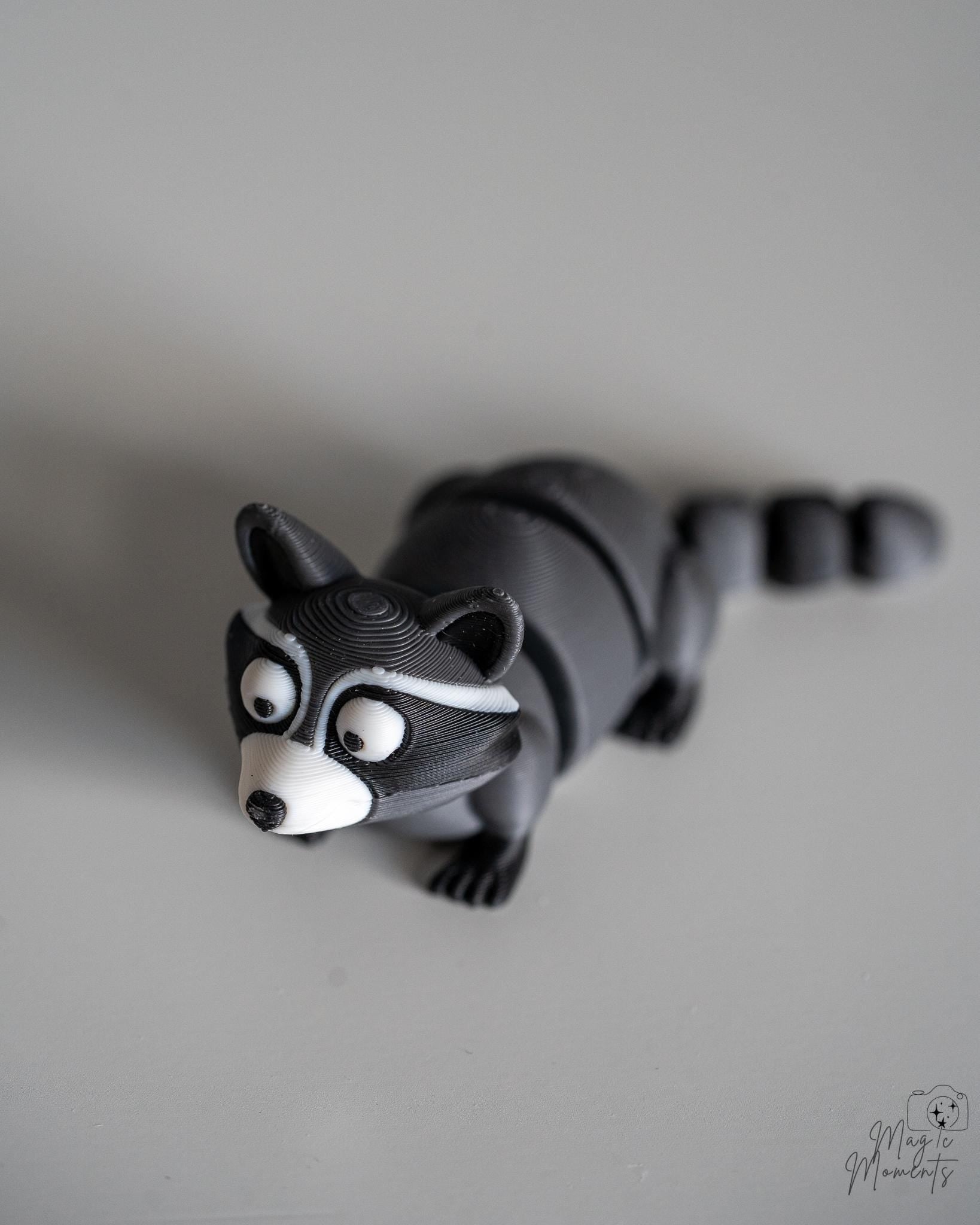Articulated raccoon figure with segmented body and striped tail