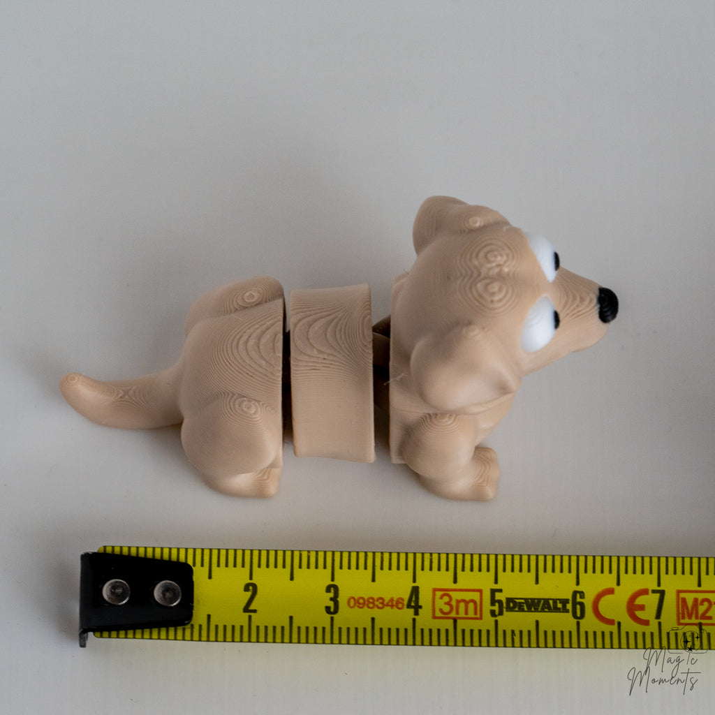 beige labrador figurine next to measuring tape for scale