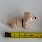beige labrador figurine next to measuring tape for scale