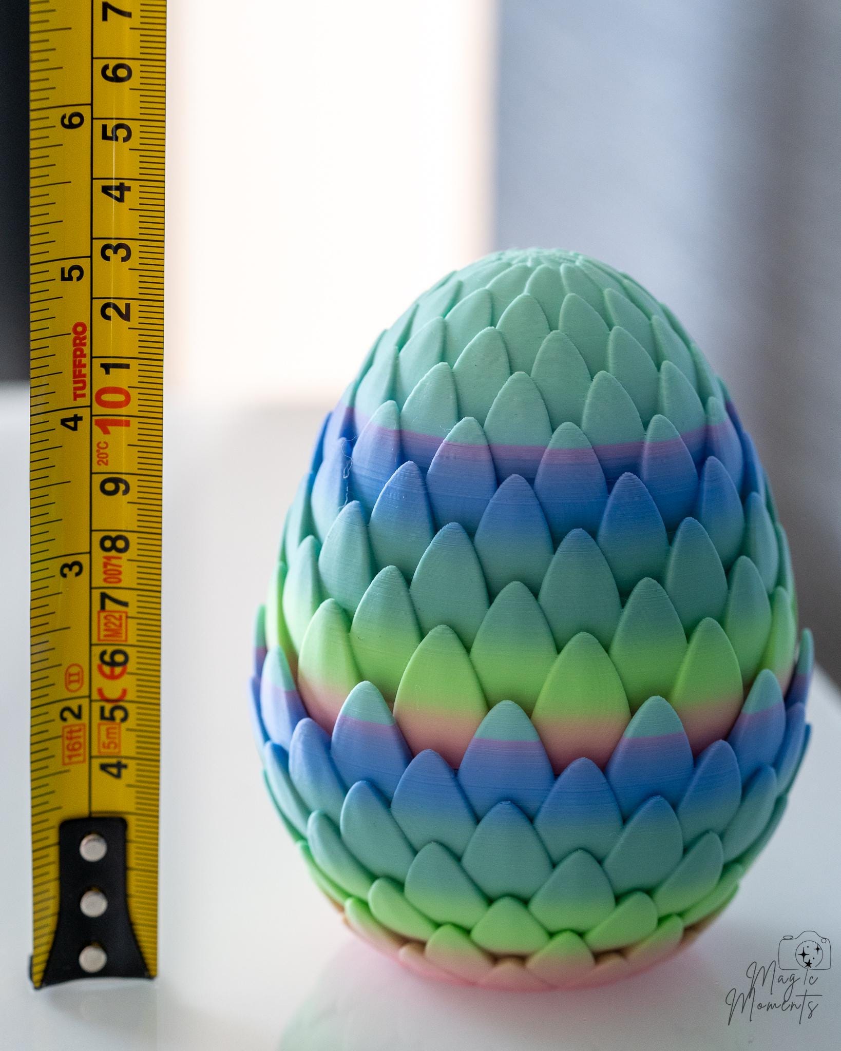 dragon egg next to measuring tape for scale