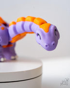 Cute smiling dinosaur figure with orange spikes and tail details
