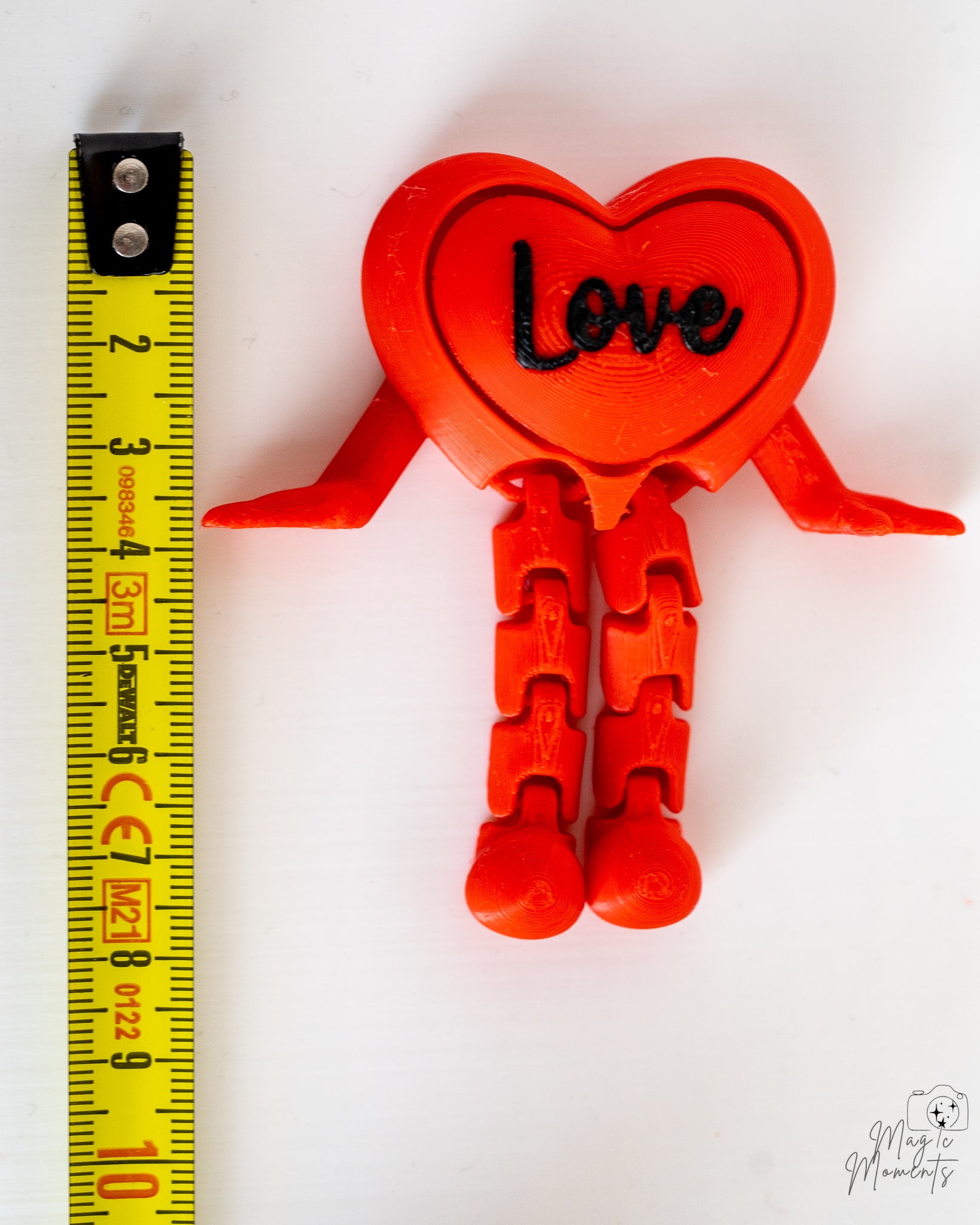 Love heart clicker next to measuring tape for scale