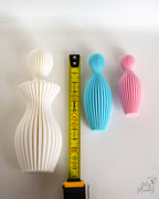 Family sculptures next to measuring tape for scale