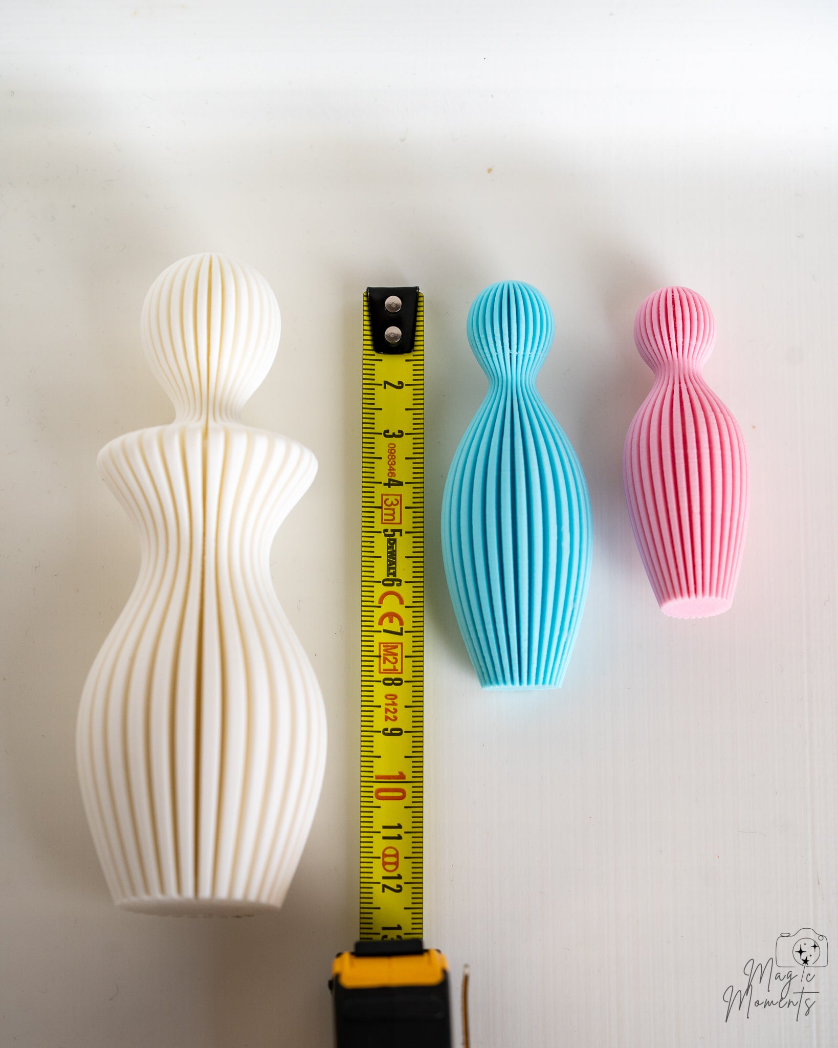 Family sculptures next to measuring tape for scale