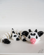 Cow dragon with black and white pattern on a white background