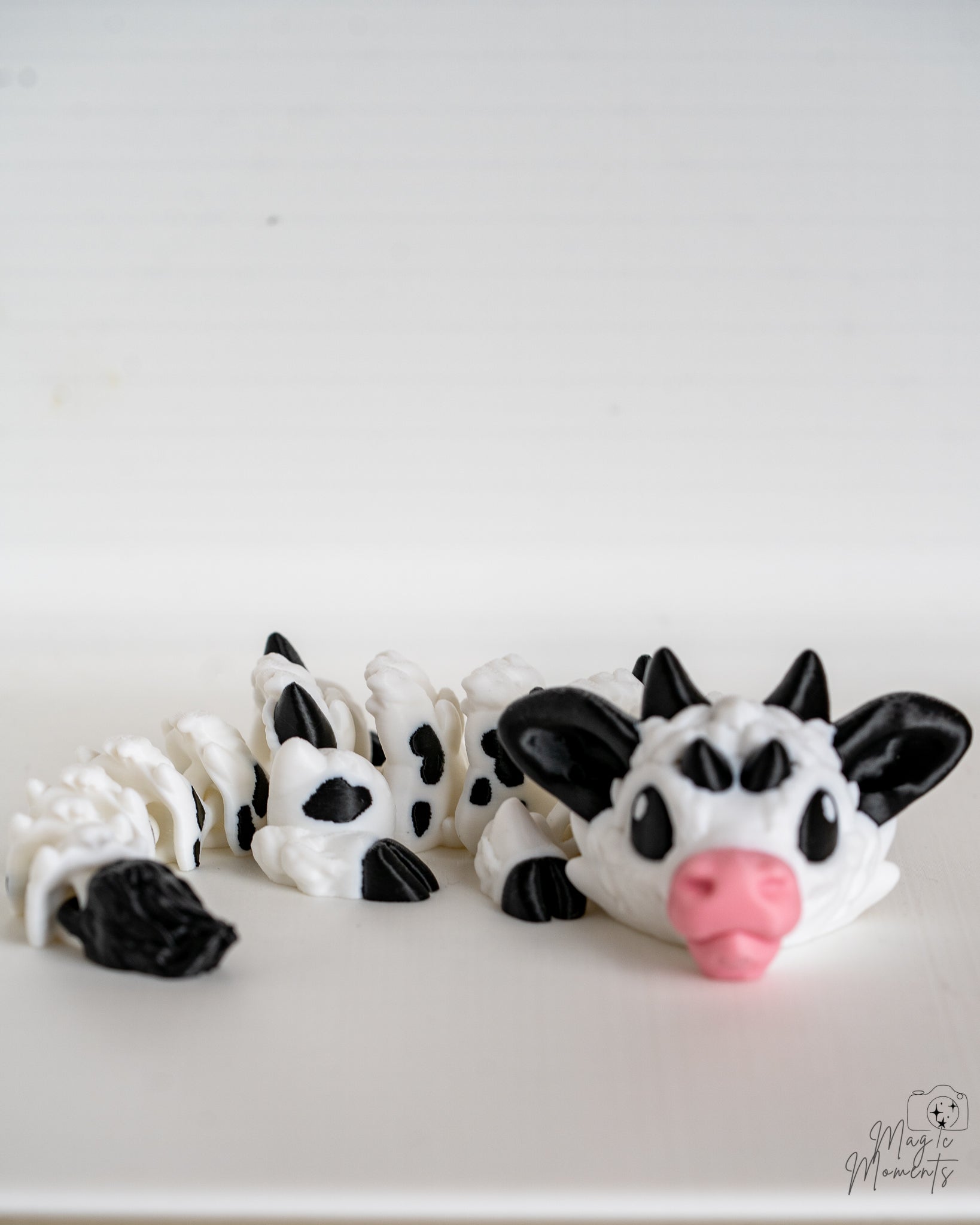 Cow dragon with black and white pattern on a white background
