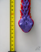 Purple dragon snake head viewed from above next to measuring tape