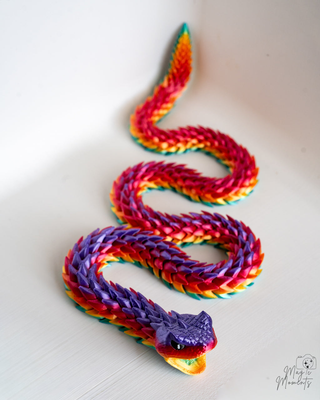 Coiled rainbow articulated snake figure