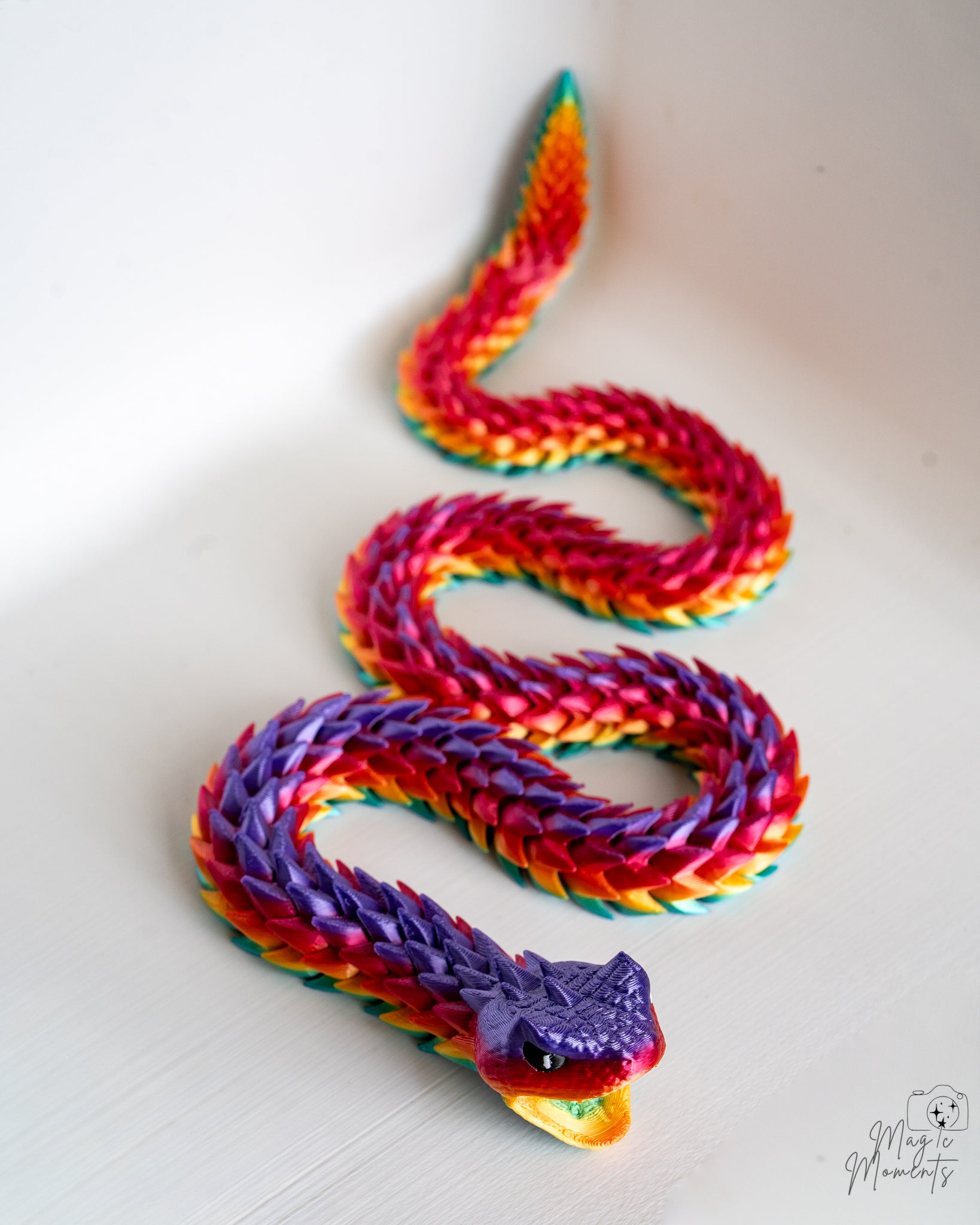 Coiled rainbow articulated snake figure
