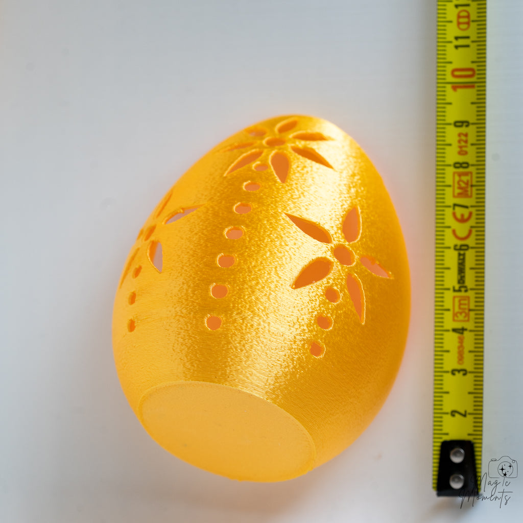 Gold egg tealight holder next to measuring tape for scale