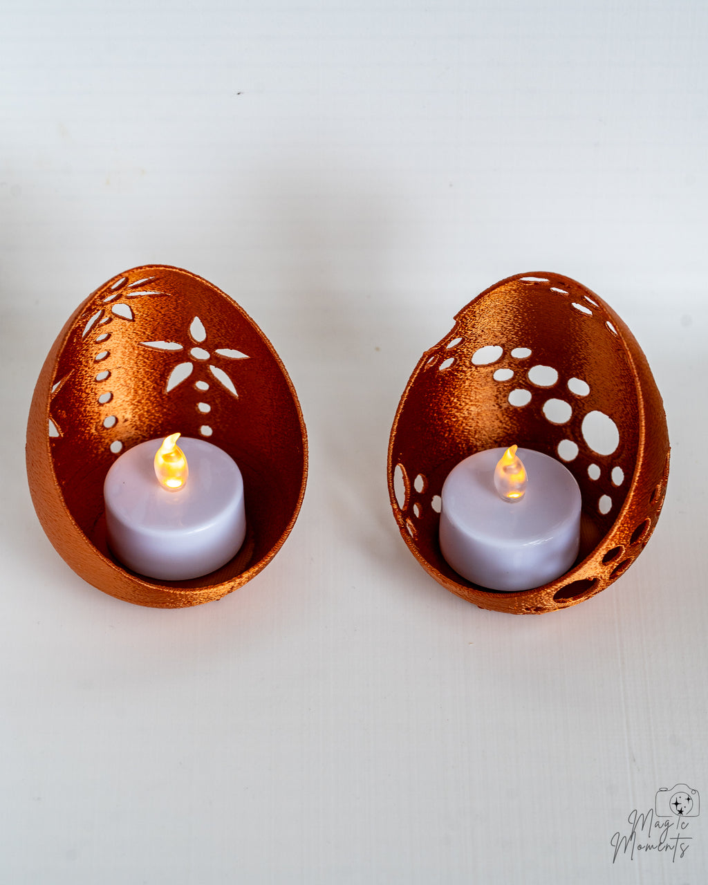 Bronze egg tealight holders with glowing LED candles