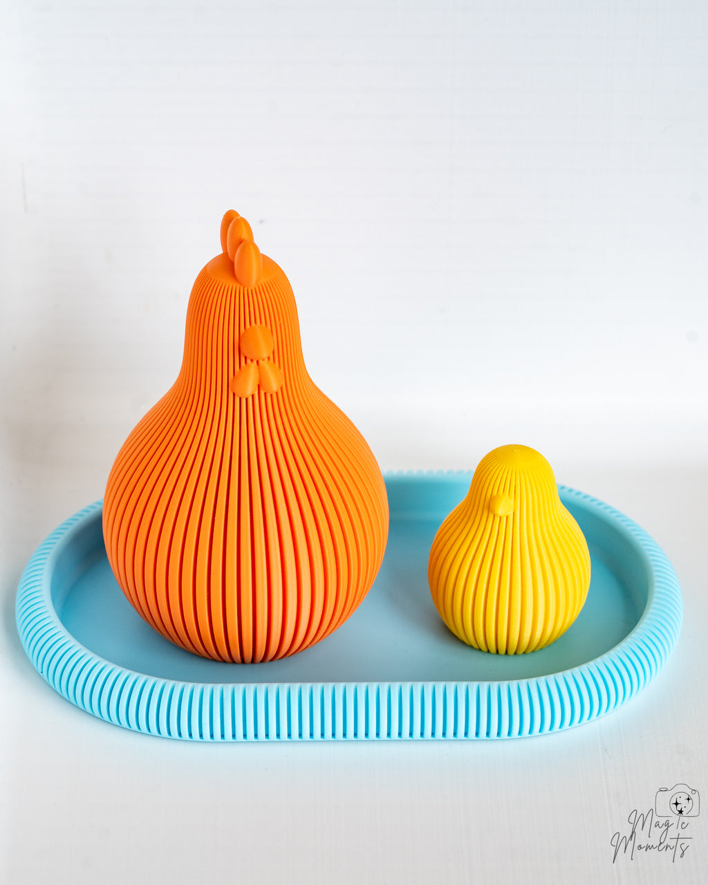 Orange and yellow ribbed chicken decor set on blue tray