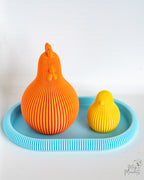 Orange and yellow ribbed chicken decor set on blue tray