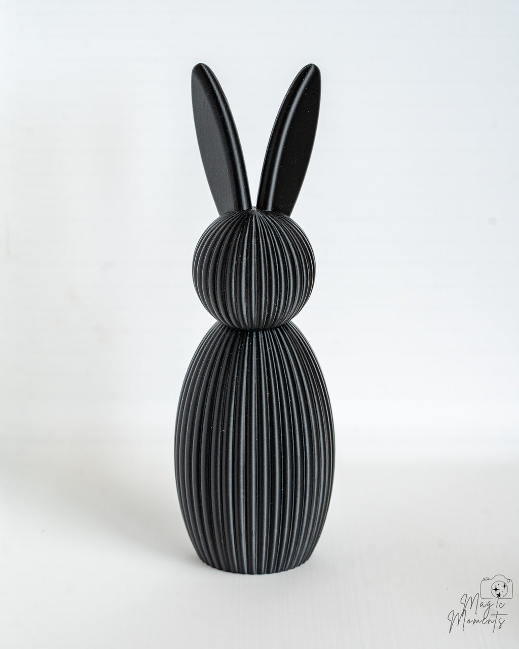 Black ribbed bunny figure with long ears