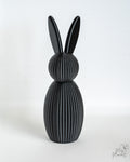Black ribbed bunny figure with long ears