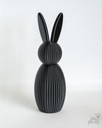 Black ribbed bunny figure with long ears