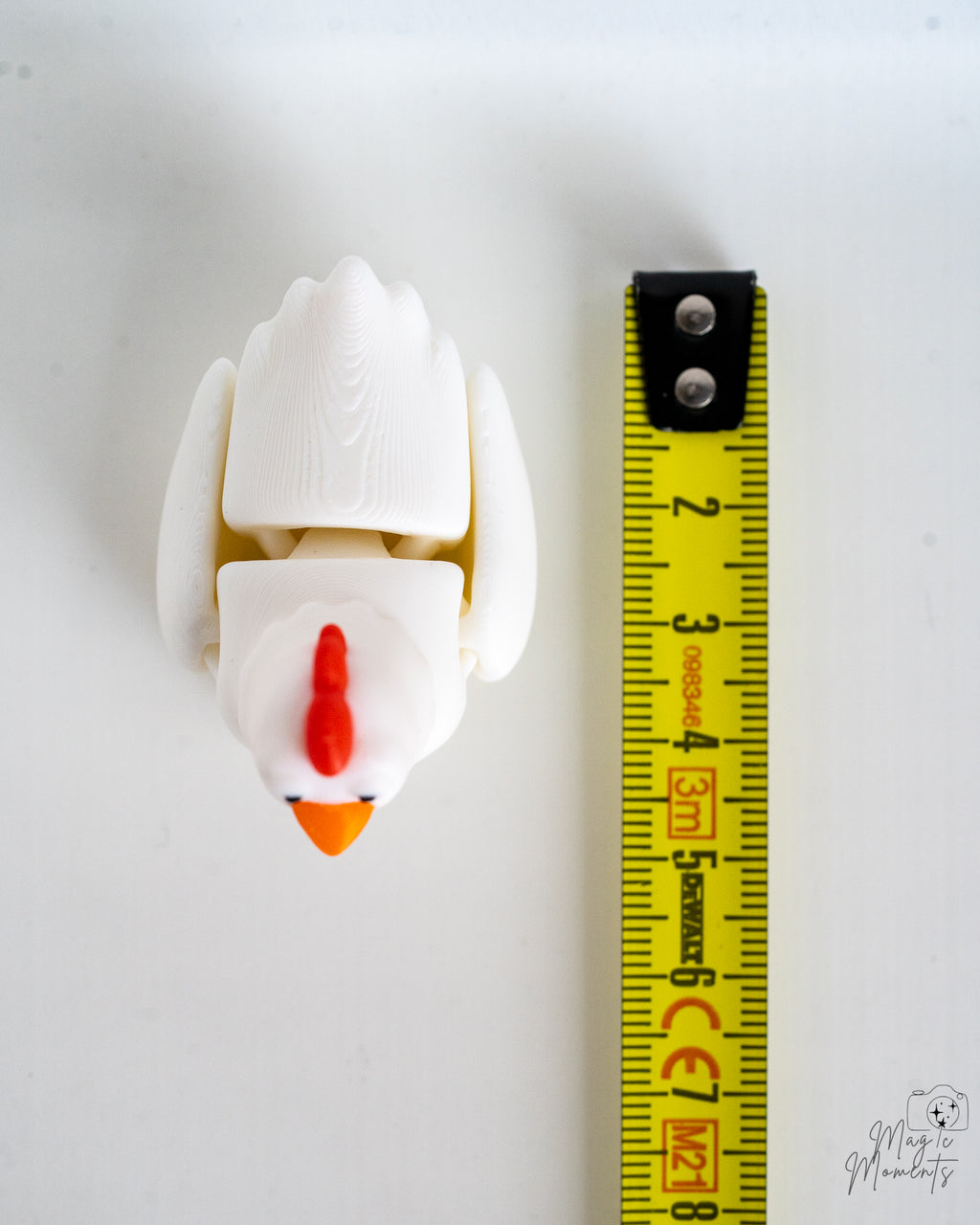 chicken figurine next to measuring tape for scale