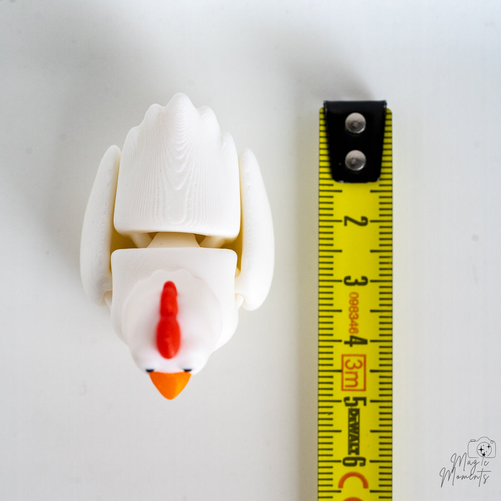 chicken figurine next to measuring tape for scale