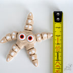 Starfish figure next to measuring tape for scale