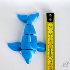 dolphin figurine with a measuring tape for scale 