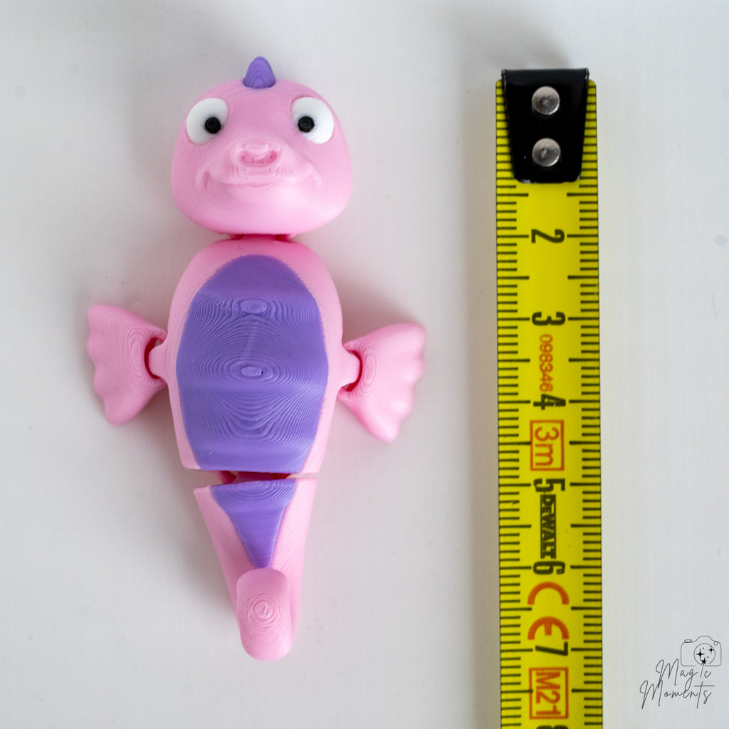 sea horse figurine with a measuring tape for scale 