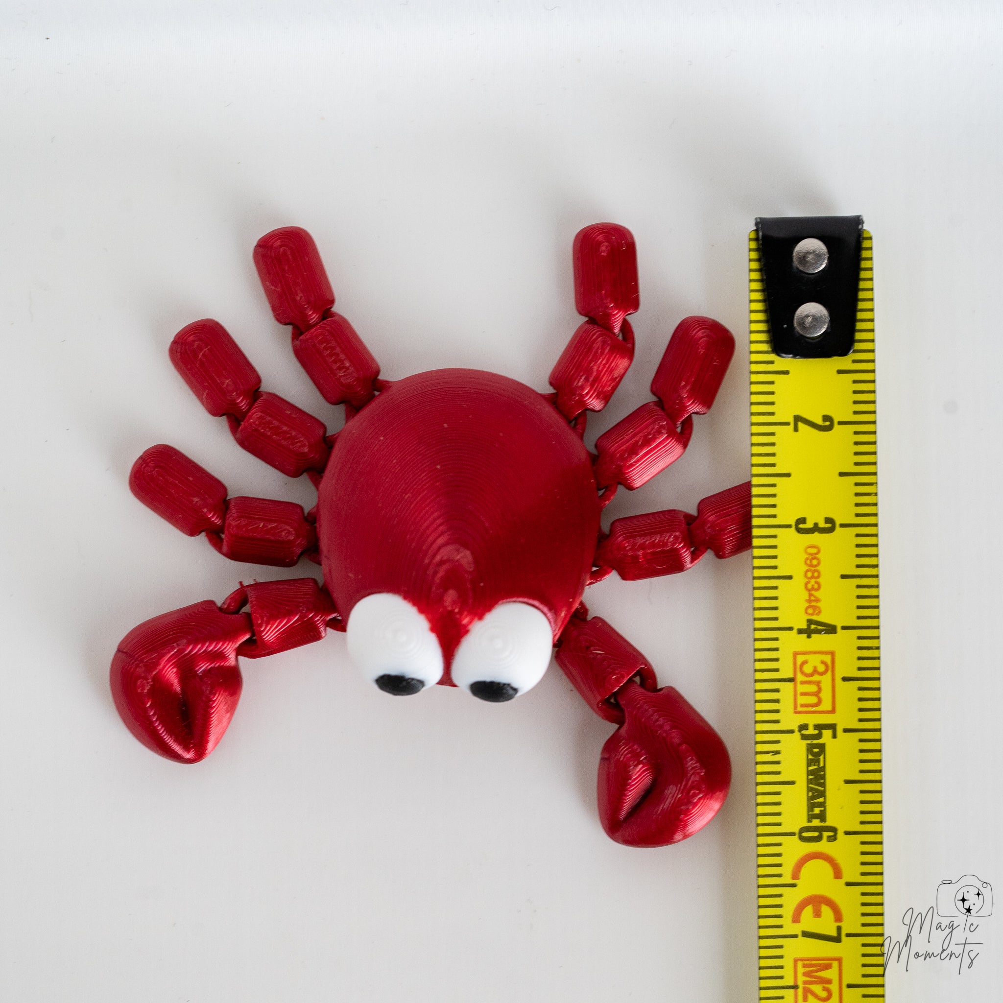 Red crab figure next to measuring tape for scale