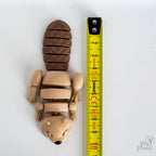beaver figurine next to measuring tape for scale