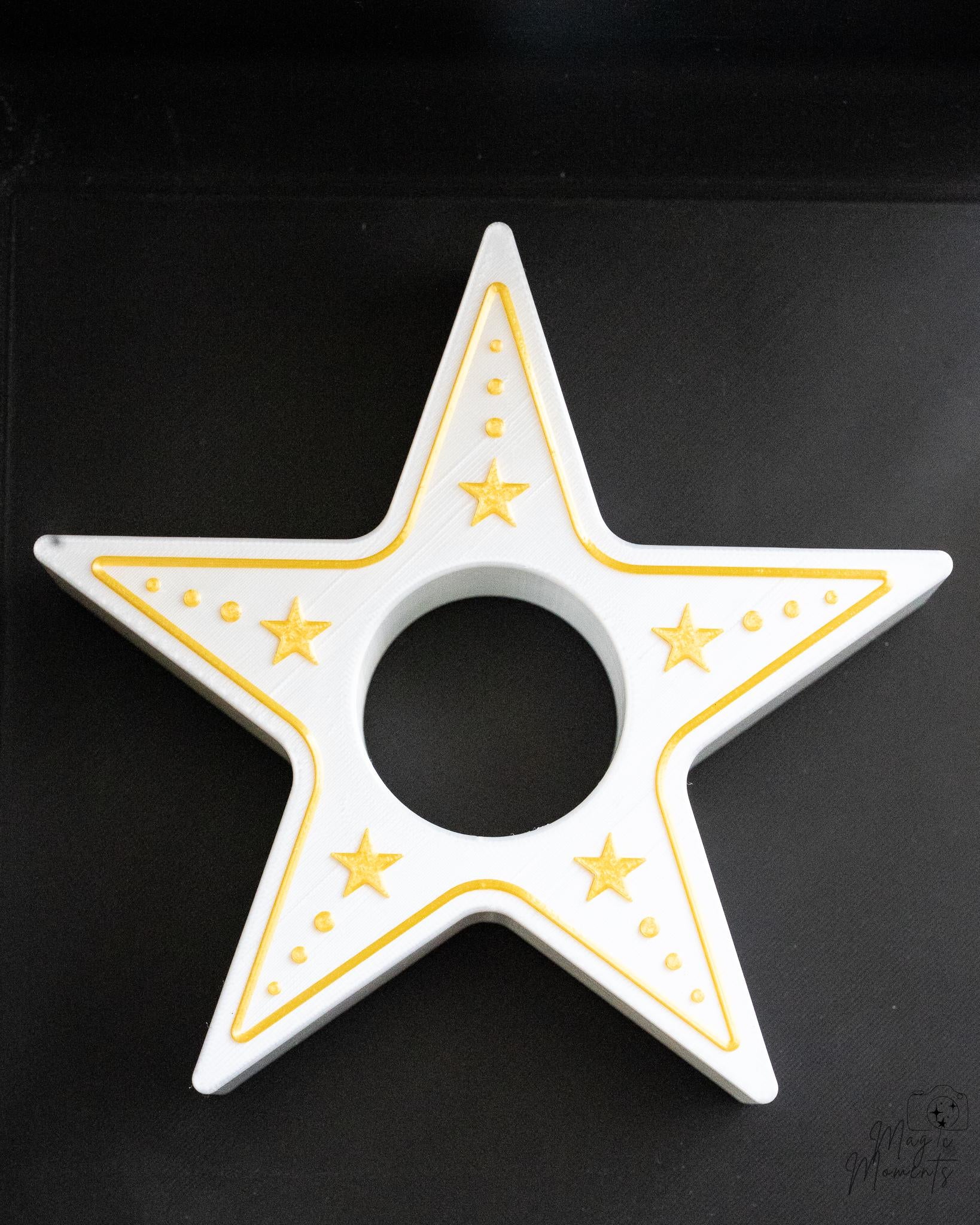 Star-shaped candle holder with gold accents on a black background