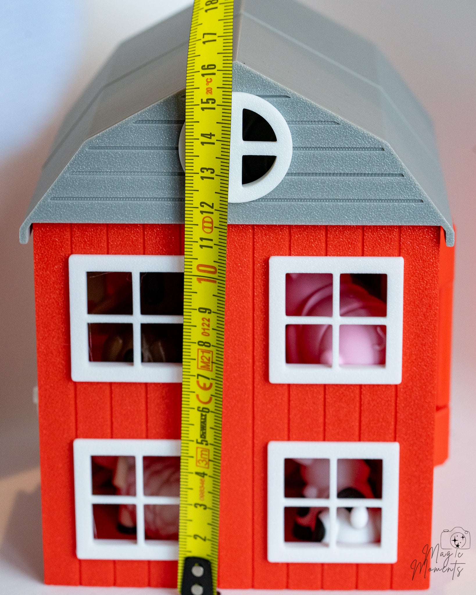 barn house next to measuring tape for scale
