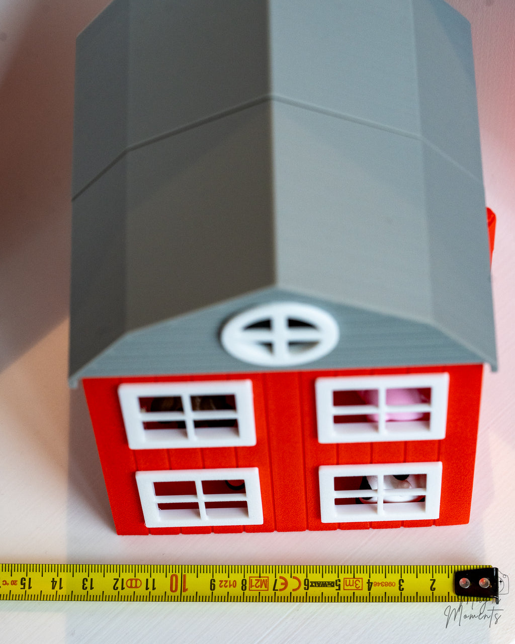 3d printed barn next to measuring tape for scale