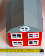 3d printed barn next to measuring tape for scale