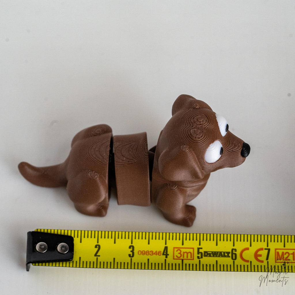 brown labrador figurine next to measuring tape for scale