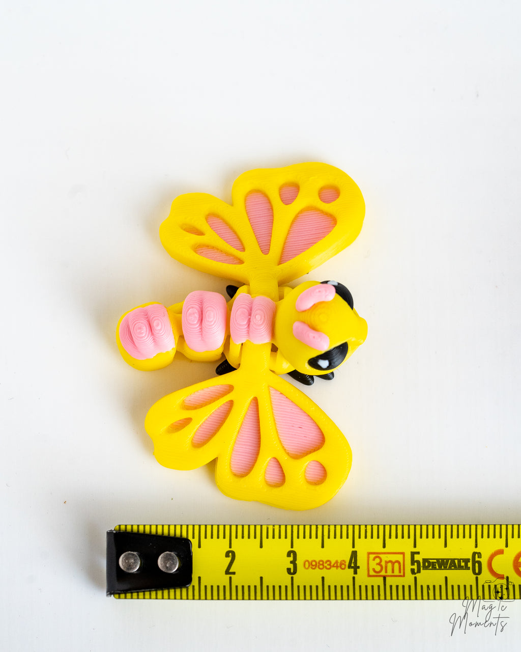 Butterfly figure next to measuring tape for scale