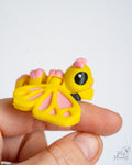 Cute pastel butterfly figure held in hand