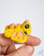 Cute pastel butterfly figure held in hand