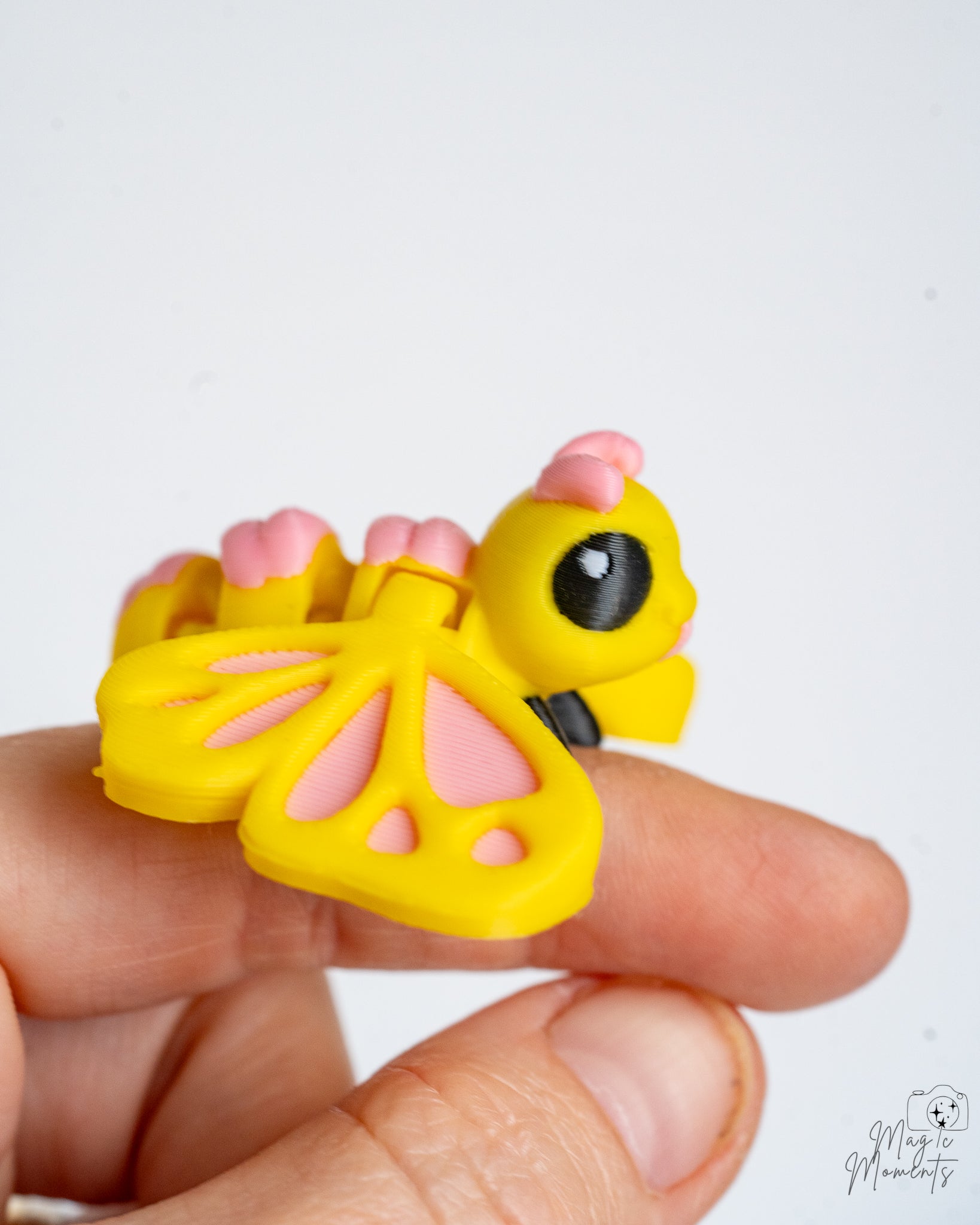 Cute pastel butterfly figure held in hand