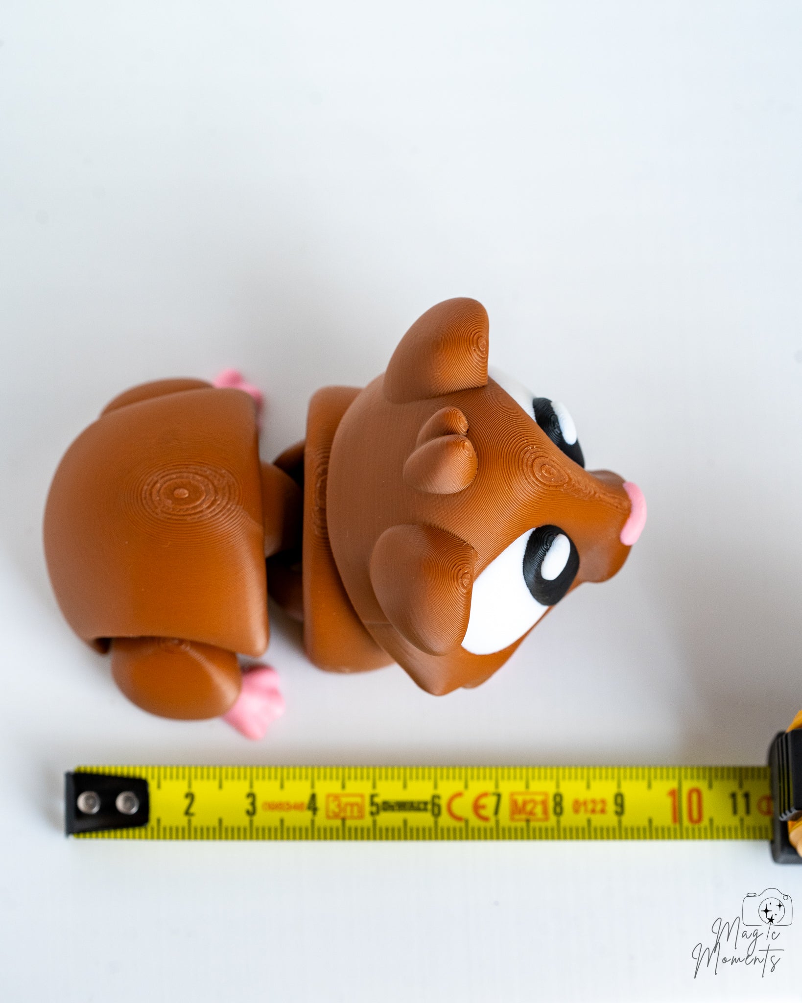 Guinea pig figure next to measuring tape for scale