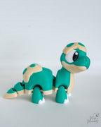 Teal baby dinosaur figure with spotted shell pattern