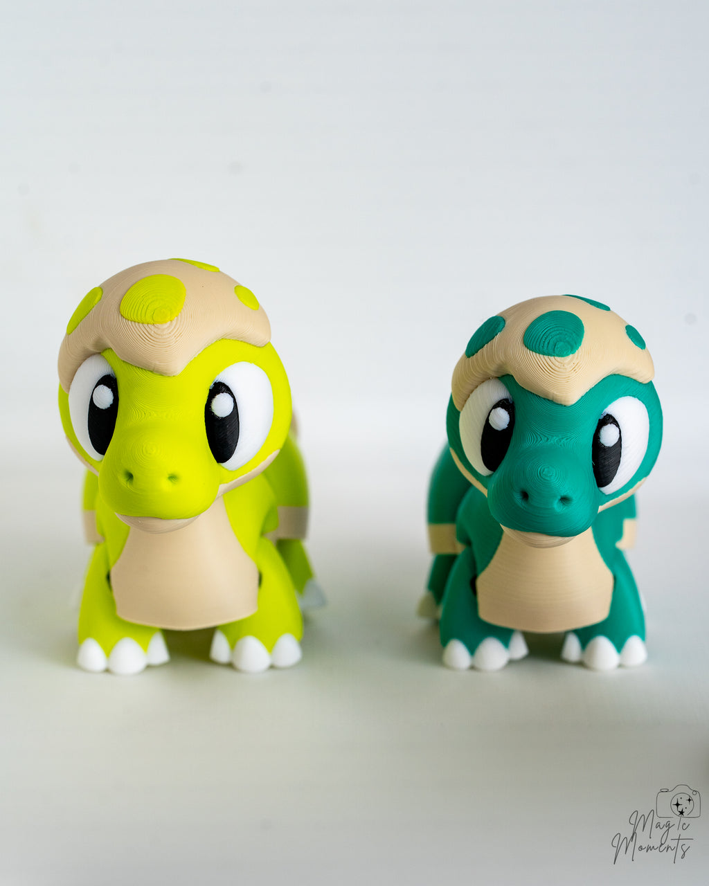 Cute baby dinosaur figures in green and teal colours