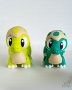 Cute baby dinosaur figures in green and teal colours