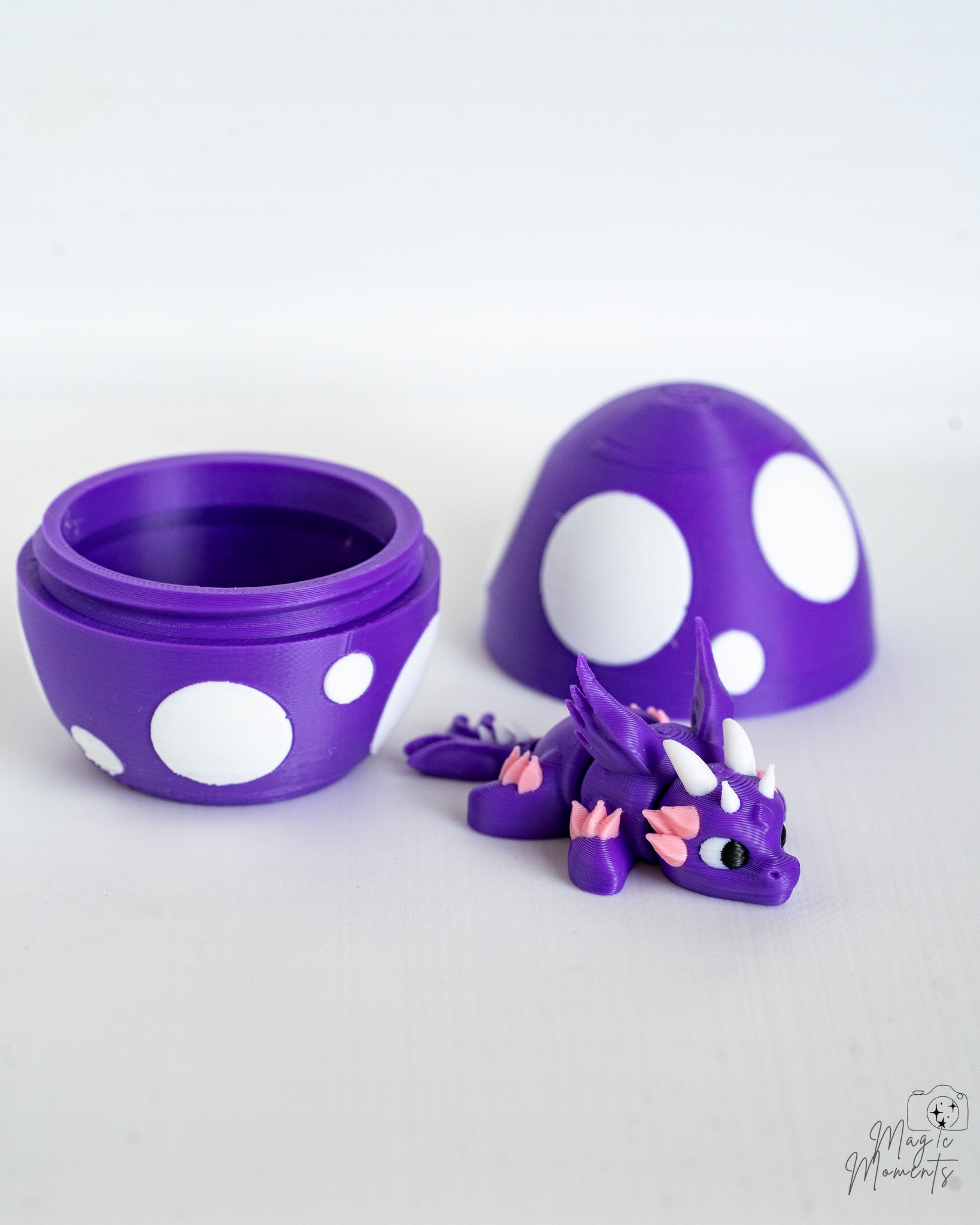 Mini purple dragon beside decorative egg container