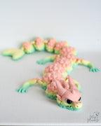 3D printed pastel dragon in soft rainbow colours