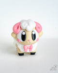 Cute sheep figure with pink bow