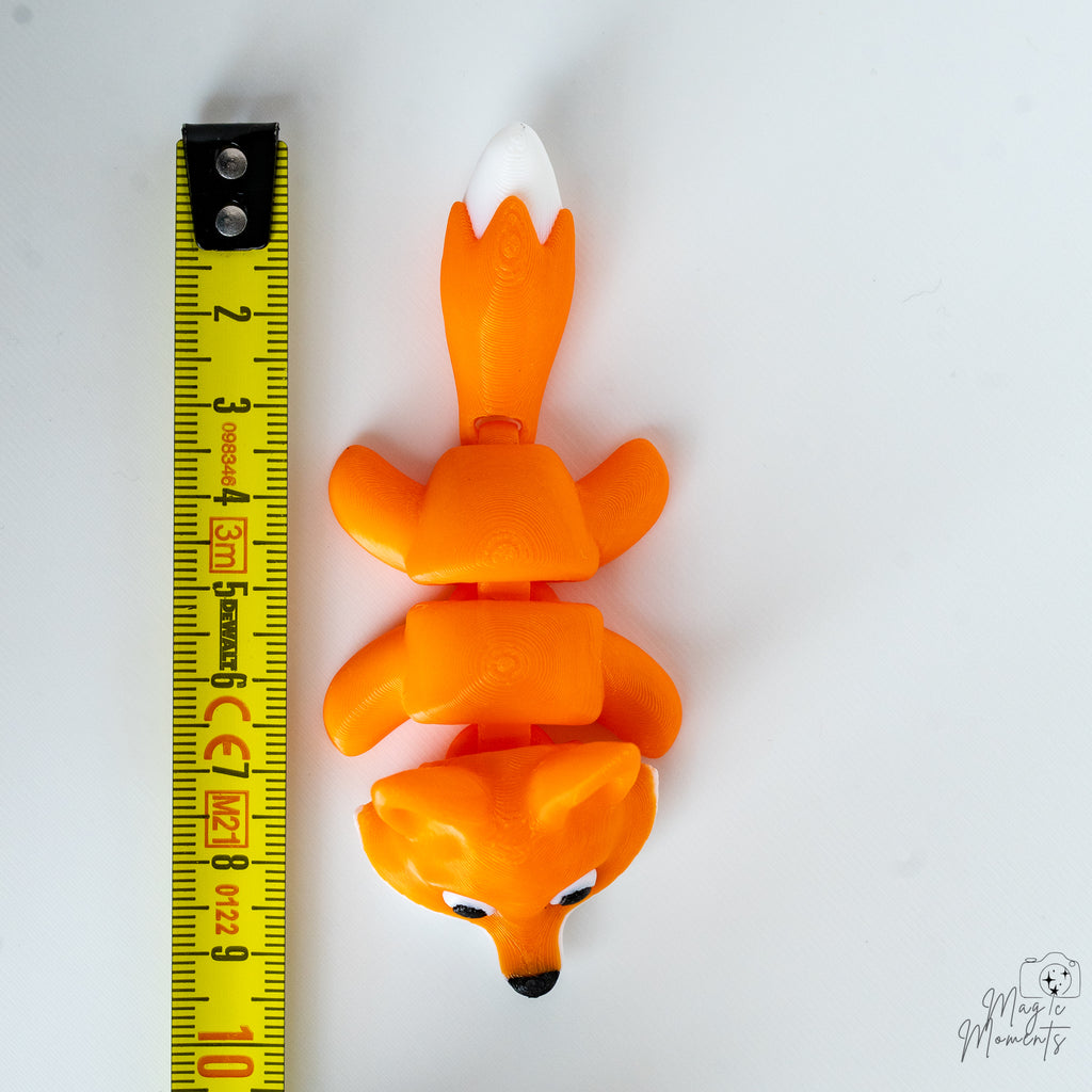 fox figurine next to measuring tape for scale
