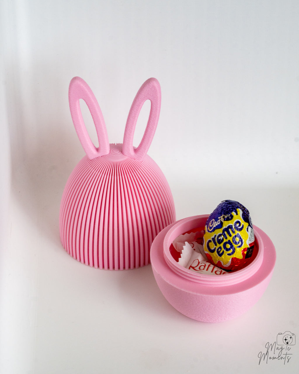 3D printed pink Easter egg containers with rabbit ear lids and hidden storage