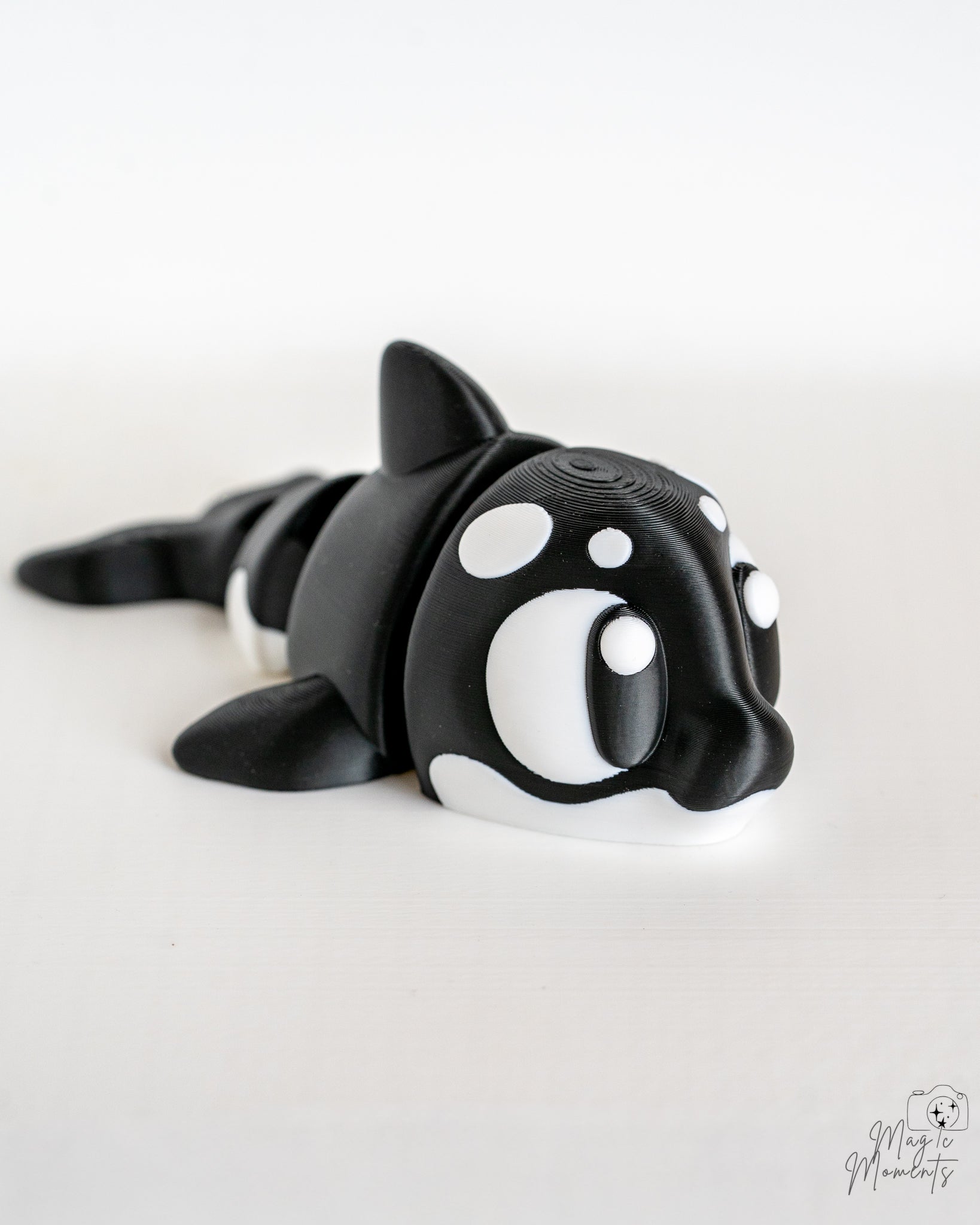 Mini orca figurine with cartoon eyes