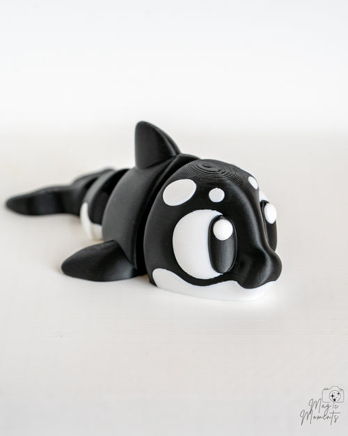 Mini orca figurine with cartoon eyes