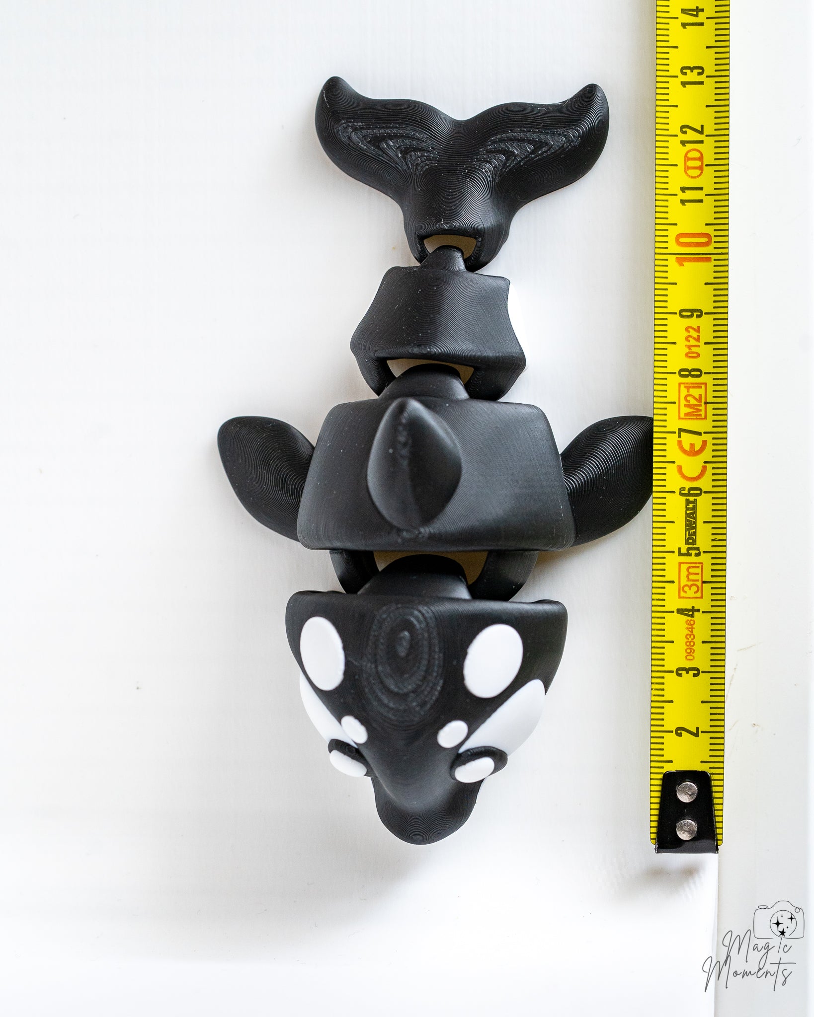 Orca figure next to measuring tape for scale