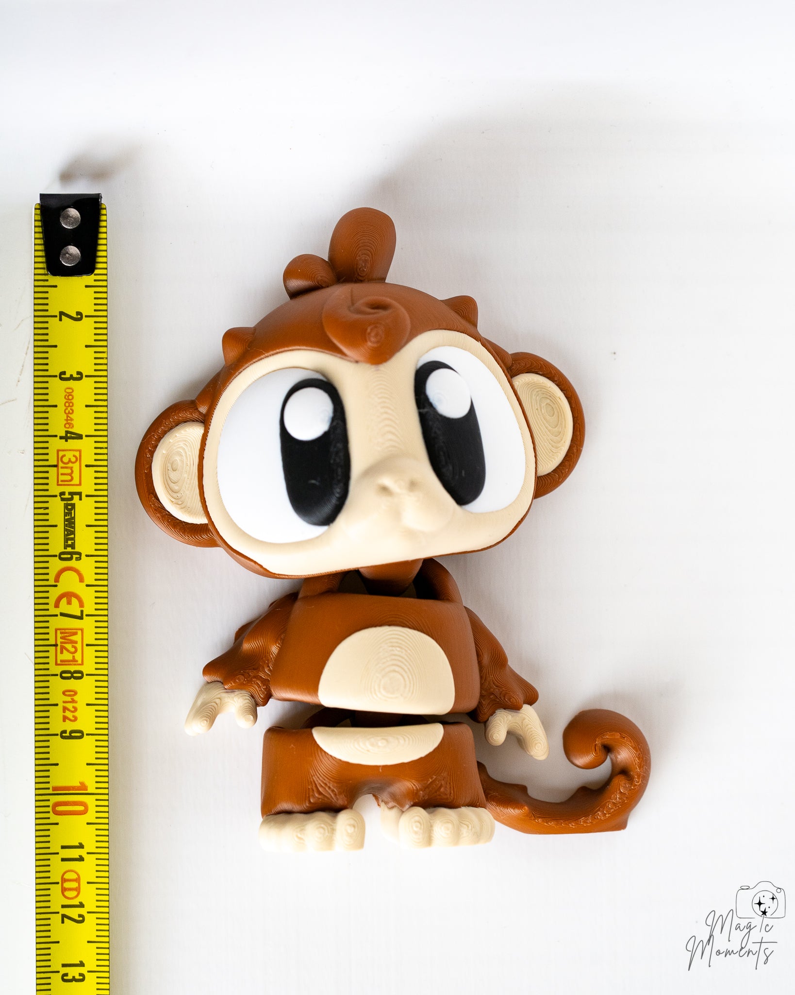 Monkey figure next to measuring tape for scale